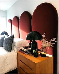 a bed room with a neatly made bed and a night stand