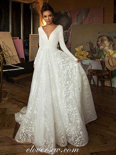 a woman in a white wedding dress posing for the camera