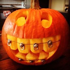 a carved pumpkin with teeth attached to it