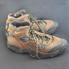 a pair of hiking boots with yellow laces