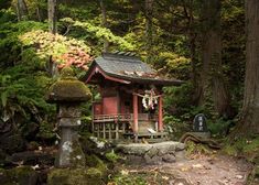 a small shrine in the woods surrounded by trees