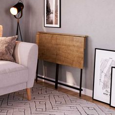 a living room with a couch, table and pictures on the wall next to it