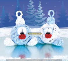 two crocheted stuffed animals laying on top of snow covered ground with trees in the background