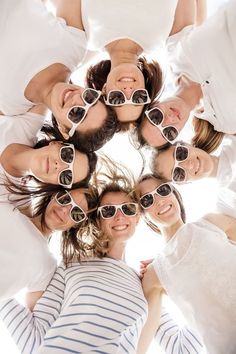 a group of people wearing sunglasses standing in a circle