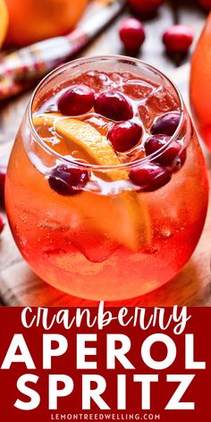 an orange and cranberry aperol spritz is garnished with cherries