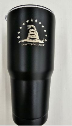 a black tumbler with the words don't tread on me printed on it