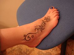 a woman's foot with a tattoo on the top and bottom of her leg