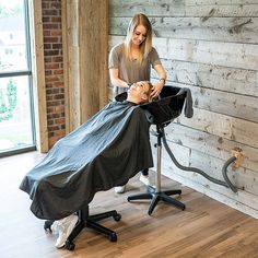 a woman getting her hair cut by a barber