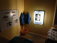 a room with some clothes hanging on the wall and a light in the corner above it