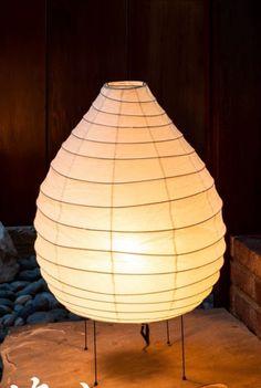 a white lamp sitting on top of a stone floor