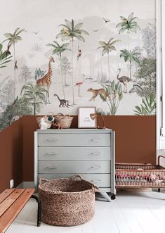 a baby's room with wallpaper and furniture in the style of safari animals