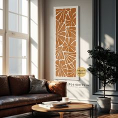 a living room with a couch, coffee table and potted plant in the corner