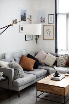 a living room filled with furniture and pillows