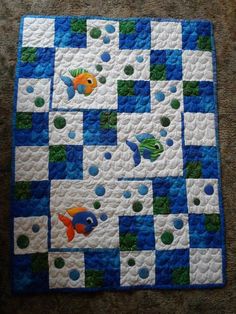 a blue and white quilt with fish on it