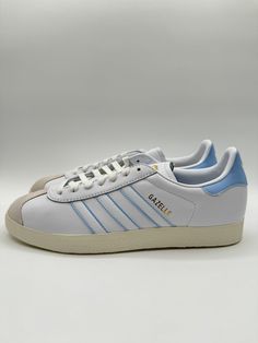 This stylish pair of Adidas Gazelle sneakers in blue and white is a must-have for any soccer enthusiast. Featuring the Argentina AFA World Cup design, these athletic shoes are perfect for casual wear or for playing the game. The size 9 sneakers come brand new in the box, and are made from high-quality materials for durability and comfort. The iconic Adidas stripes in multicolor add a touch of fun to the design, while the style code ID3718 and product line name make them a sought-after addition to any sneaker collection. Whether you're a collector or simply looking for a comfortable pair of shoes, these Adidas Gazelle sneakers are the perfect fit. Multicolor Sneakers, Classic Adidas, Sneaker Games, Adidas Gazelle Sneaker, Adidas Gazelle, Athletic Sneakers, Sneaker Collection, Colorful Design, Cup Size