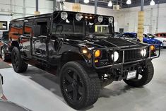 a black hummer truck parked in a garage