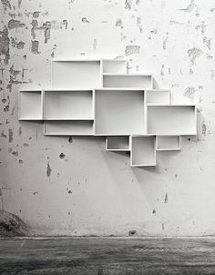 a white shelf sitting on the side of a wall