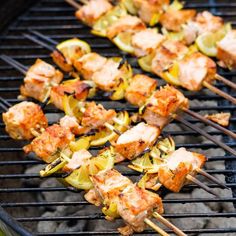 several skewered meats and vegetables on a grill