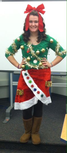 a woman dressed up as santa clause standing in front of a whiteboard