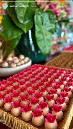 there is a tray that has some cupcakes on it and flowers in the background