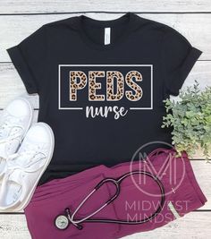 a t - shirt with the word er nurse on it next to a pair of running shoes