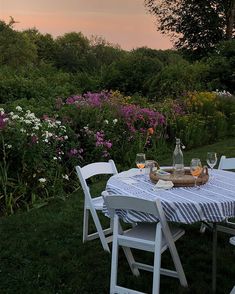 an outdoor table set for two in the grass