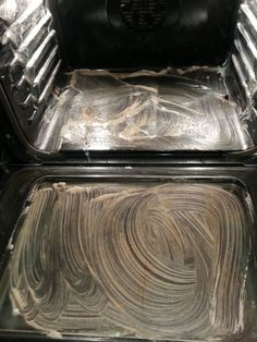 the inside of an oven that is covered in tin foil and has been left open