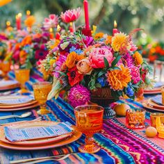 a colorful table setting with flowers and candles