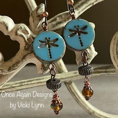 “Summer Dragon” - Dangle Earrings Hand Created - Once Again Designs By Vicki Lynn Limited Edition Fun Earrings That Feature Dragonfly Coin Beads Paired With Repurposed Vintage Textured Metal And Czech Glass Beads. This Pair: - New Czech Glass Coin Dragonfly Beads. - Repurposed Vintage Metal Beads With Textured Stripes. - Beautiful Czech Glass Bead Dangle With Lovely Turquoise Blue And Rich Brown Swirls. - Tierracast Niobium Hypoallergenic French Hook Ear Wires With Copper Bead. - Length: Just Sl Czech Beads Jewelry, Dragonfly Beads, Czech Glass Jewelry, Handmade Boho Jewelry, Spring Earrings, Earring Ideas, Repurposed Vintage, Artisan Earrings, Glitter Earrings