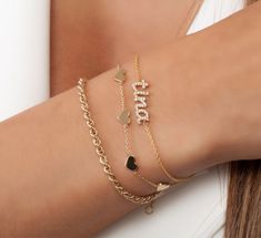 This 14k personalized diamond name bracelet is the perfect gift for the bridal party, someone special, or yourself.* All letters are lowercase__________________________________________M A T E R I A L & L E N G T HAvailable in 14k Yellow Gold, 14k Rose Gold, 14k White Gold, Sterling SilverThickness: 1.2mm / 0.05"Initials: 5 mm.Stone: Natural DiamondsDiamond: 0.15 ct. - 0.40 ct. depending on the nameBracelet length: 6+1 inches (Please let us know if you prefer a different length), 14k link chainCo Gold Heart Bracelet, Station Bracelet, Name Bracelet, Stone Heart, Love Bracelets, Heart Bracelet, Heart Charm Bracelet, Silver Rose Gold, Silver Bracelets