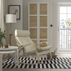 a living room with a rocking chair and rug