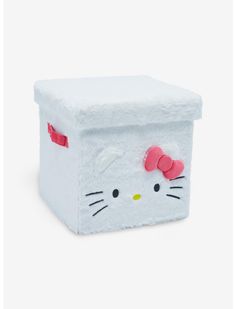 a white hello kitty storage box with a pink bow on the top and eyes painted on it