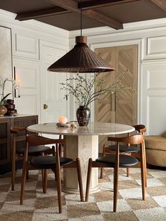 a dining room table with two chairs around it