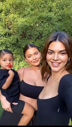 two women and a child posing for a photo