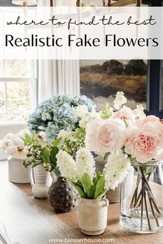 vases filled with flowers sitting on top of a wooden table