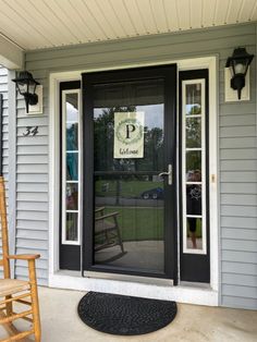 the front door of a house with a welcome sign on it's glass window