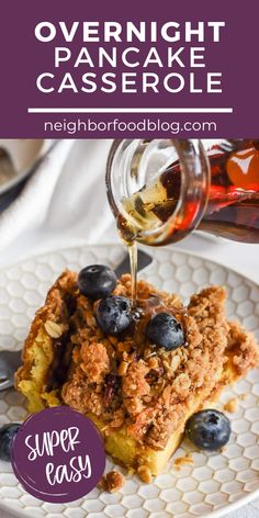 blueberry overnight pancake casserole on a plate with syrup being poured over it