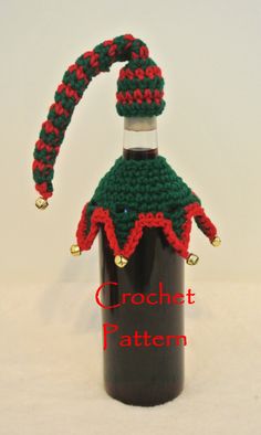 a bottle with a knitted christmas hat on it