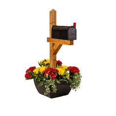 a mailbox and flowers in a flower pot