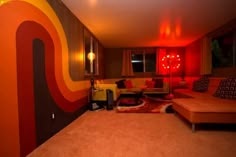 a living room filled with furniture and red lights on the wall above it's couches