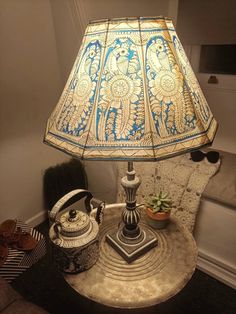 a lamp sitting on top of a table next to a chair