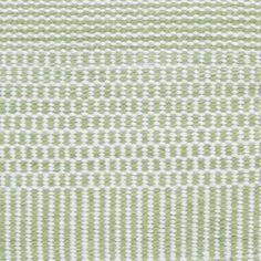 a green and white rug with lines on it