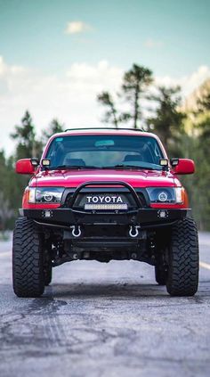 the front end of a red toyota truck