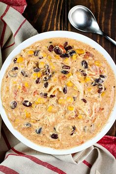 a bowl of oatmeal with raisins, corn and black beans