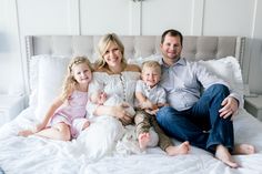 a family sitting on a bed together