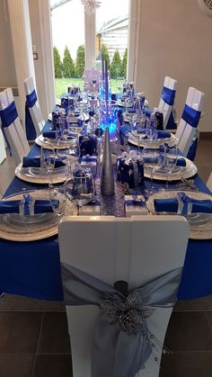 the table is set with blue and white linens