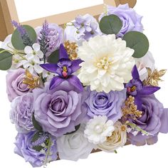 a bouquet of purple and white flowers in a wooden box