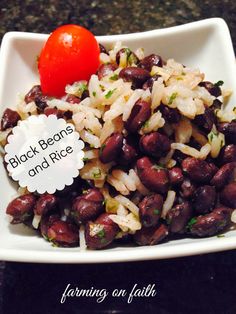 beans and rice in a white bowl with a tomato on the side that says, black beans and rice