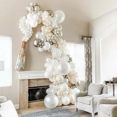 a living room filled with furniture and balloons on the wall in front of a fire place