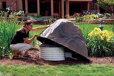 a woman is working on a large rock in the garden